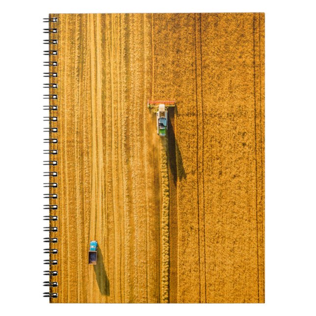 Harvester machine working in field. Combine harves Notebook (Front)