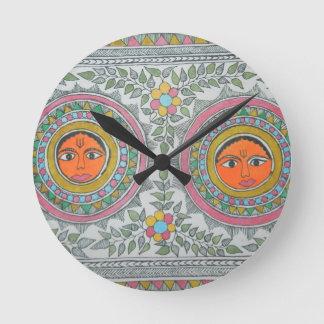 has a "sun" motif in "madhubani painting" style. round clock