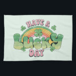 Have a Lucky Day Retro Typography Tea Towel<br><div class="desc">A kitchen towel with a St. Patrick's Day themed image. A retro grunge style design which says: Have a lucky day. With a colourful rainbow behind. Words written in a fat rounded retro style vibe. Pink and green colours.</div>