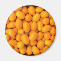 Heap of orange kumquats in cardboard box