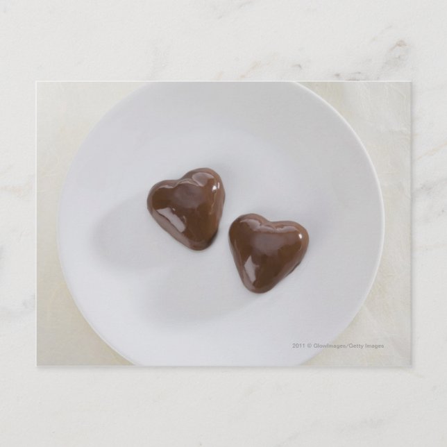 Heart shaped chocolate candies on a plate postcard (Front)
