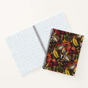 Hedgehogs and autumn forest flora on black notebook