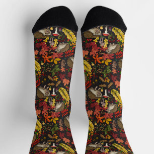 Hedgehogs and autumn forest flora on black socks