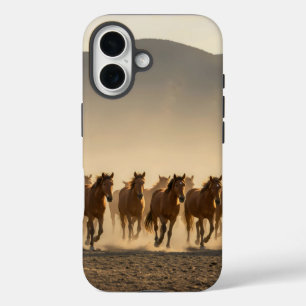 herd of wild horses galloping across a dusty iPhone 16 case