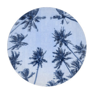 High palm trees, clear blue sky. cutting board