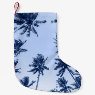 High palm trees, clear blue sky. small christmas stocking