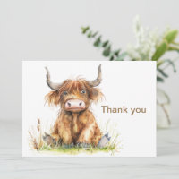 Highland Cow Sitting in Grass