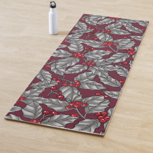 Holly berry, gray leaves on dark red yoga mat