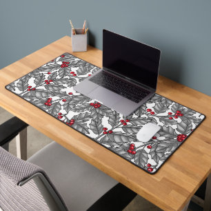 Holly berry, gray leaves on white desk mat