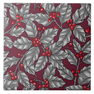 Holly berry, grey leaves on dark red ceramic tile