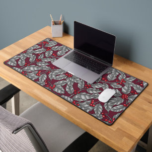 Holly berry, grey leaves on dark red desk mat