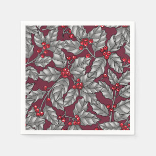 Holly berry, grey leaves on dark red napkin