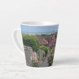 Hollyhocks alongside St Leonards Church wall Hythe Latte Mug