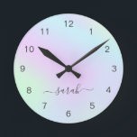 Holographic Girly Modern Elegant Script Name Round Clock<br><div class="desc">Modern wall clock featuring your name in an elegant handwritten script with swashes over a colourful holographic gradient in pastel pink,  purple,  blue and green. This stylish and feminine wall clock is great for a girly girl and makes a great gift for her.</div>