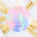 Holograpic unicorn glitter thank you bridal shower classic round sticker<br><div class="desc">A trendy holographic background with unicorn colours and rainbow colours in pink, purple, rose gold, mint green. Decorated with faux glitter drips in rose gold, pink and purple. The text: Thank You. Personalise and add your name, written with a modern hand lettered style script with swashes. Purple letters. To keep...</div>