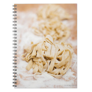 Homemade ribbon pasta, close up notebook