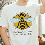 Honeybee Honeycomb Bee Farm Apiary Personalised T-Shirt<br><div class="desc">This honeybee t-shirt has a large bee over a light, bright honeycomb background. The yellow and black bee has white-blue wings that spread out like it's ready to fly. The background is a pretty golden beehive honeycomb shape. Use the template to add any text you like, such as your bee...</div>