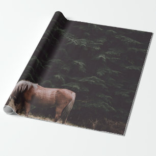 HORSE GRAZING IN THE SHADE OF CONIFERS WRAPPING PAPER