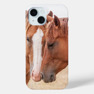Horses nuzzling in a pasture iPhone 15 case