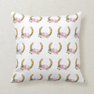 Horseshoe and flowers on white cushion