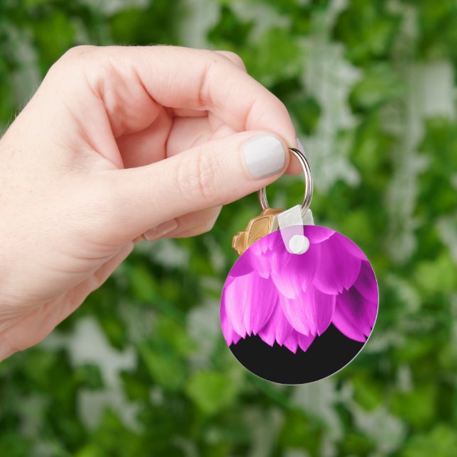 Hot pink flower petals on black key ring (Hand)