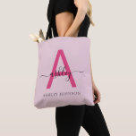 Hot Pink Modern Script Girly Monogram Name Tote Bag<br><div class="desc">Elevate your everyday style with this custom monogram tote bag. Featuring a striking hot pink letter “A” and elegant script that personalises your name, this tote blends modern minimalism with a girly touch. Its spacious, durable design makes it the perfect accessory for any occasion—whether you’re running errands, heading to class,...</div>