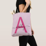 Hot Pink Modern Script Girly Monogram Name Tote Bag<br><div class="desc">Elevate your everyday style with this custom monogram tote bag. Featuring a striking hot pink letter “A” and elegant script that personalises your name, this tote blends modern minimalism with a girly touch. Its spacious, durable design makes it the perfect accessory for any occasion—whether you’re running errands, heading to class,...</div>