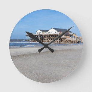 House on stilts at the beach of St. Peter Ording Round Clock