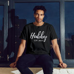 Hubby White Script "EST 202X" - Modern Groomsmen  T-Shirt<br><div class="desc">Celebrate the groom-to-be with this stylish and personalised "Hubby Est. 202X" groomsmen bachelor party shirt. This black t-shirt features a modern and elegant design, making it a must-have for any pre-wedding celebration. Crafted from high-quality, comfortable fabric, it's perfect for a night out with the groomsmen or a casual daytime event....</div>