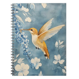 hummingbird in flight amidst white flowers notebook