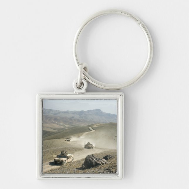 Humvees traverse rugged mountain roads key ring (Front)