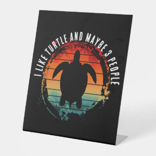 I LIKE TURTLE AND MAYBE 3 PEOPLE PEDESTAL SIGN