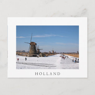 Ice skating along the windmills in winter postcard