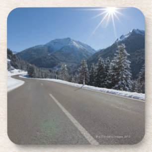 Idyllic empty road thrugh a winter landscape, coaster