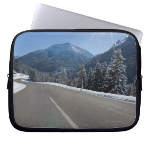 Idyllic empty road thrugh a winter landscape, laptop sleeve