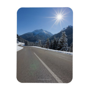 Idyllic empty road thrugh a winter landscape, magnet