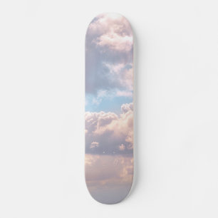 Illuminated pink fluffy clouds in a blue sky skateboard