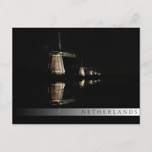 Illuminated windmills at night bar postcard
