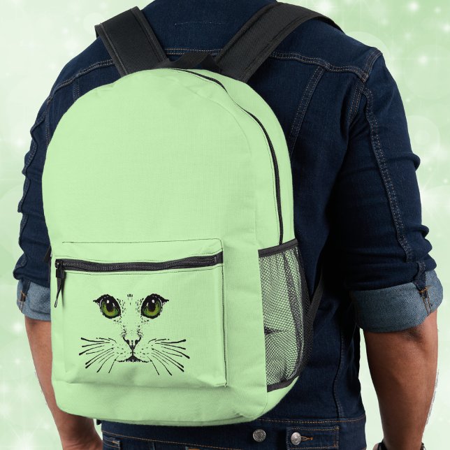 Illustration Black Cat Face Vivid Green Eyes Printed Backpack (Illustration of black cat face vivid green eyes long whiskers on light green backpack.)