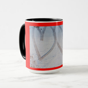 imprint of two hearts drawn in the snow on a mug