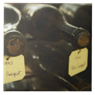In the underground wine cellar: lying bottles in ceramic tile