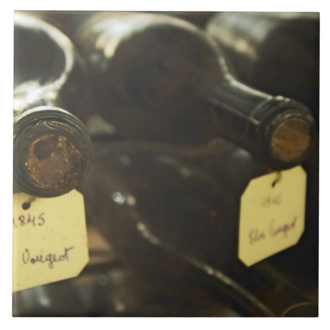 In the underground wine cellar: lying bottles in ceramic tile (Front)