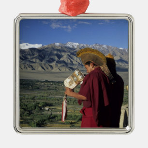 India, Ladakh, Thikse. Buddhist monk blows Metal Tree Decoration
