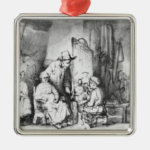 Interior of studio with painter painting metal ornament