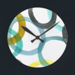Interlocking Yellow & Blue Circles Round Clock<br><div class="desc">A simple print of interlocking yellow and blue circles by Megan Meagher. The white background lets the colours of the circles pop. Purchase yours today!</div>