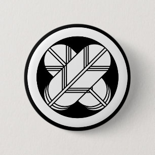 Intersecting hawk feathers in a circle 6 cm round badge