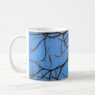 Intricate Bare Branches Silhouette Against Vivid B Coffee Mug