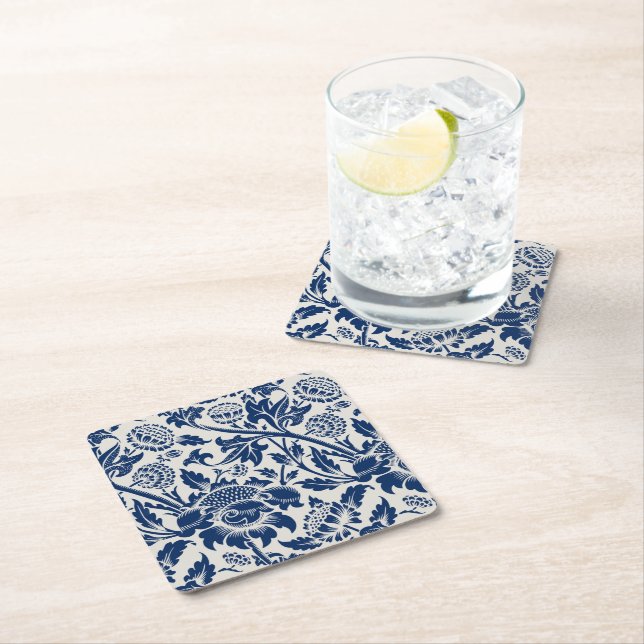 Intricate blue floral pattern on light background square paper coaster (Insitu)