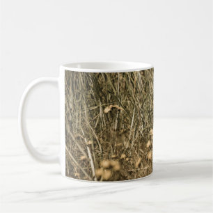 irregular dry plants on rock covered beach on the coffee mug