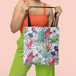 Island Style Tropical Floral Pattern and Monogram Tote Bag<br><div class="desc">In vibrant island style, this tropical themed tote has a colourful pattern of exotic orchids, lilies and parrot flowers with scattered palm fronds and foliage over a contrasting white background. An aqua round frame placed at the top of the bag includes a text template for personalising with your desired name...</div>
